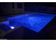 Inviting blue pool with LED lights at night at 19778 W Lincoln St, Buckeye, AZ 85326