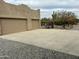 Exterior of large two car garage attached to home with desert landscaping at 38406 N 12Th Ave, Phoenix, AZ 85086