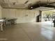 Garage interior featuring epoxy flooring, peg board, work bench, and ample lighting at 38406 N 12Th Ave, Phoenix, AZ 85086