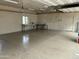 Spacious garage interior featuring epoxy flooring, work bench, and ample lighting at 38406 N 12Th Ave, Phoenix, AZ 85086