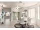 Stylish dining room featuring a glass table, modern lighting, and access to the kitchen at 5450 E Mclellan Rd # 204, Mesa, AZ 85205