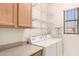 Functional laundry room featuring storage shelves, cabinets, and a washer/dryer set at 5450 E Mclellan Rd # 204, Mesa, AZ 85205