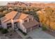 Two-story house with tile roof, three-car garage, and mountain views at 6960 E Hacienda La Noria Ln, Gold Canyon, AZ 85118