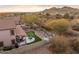Aerial view of house with backyard putting green and spa at 6960 E Hacienda La Noria Ln, Gold Canyon, AZ 85118
