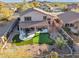 Aerial view showcasing house and backyard with putting green at 6960 E Hacienda La Noria Ln, Gold Canyon, AZ 85118