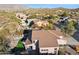 Aerial view of house with backyard putting green and mountain views at 6960 E Hacienda La Noria Ln, Gold Canyon, AZ 85118