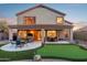 Backyard with covered patio, putting green, and multiple seating areas at 6960 E Hacienda La Noria Ln, Gold Canyon, AZ 85118