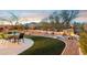 Backyard oasis with a putting green, seating area, and water feature at 6960 E Hacienda La Noria Ln, Gold Canyon, AZ 85118