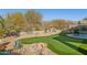 Landscaped backyard with putting green and water feature at 6960 E Hacienda La Noria Ln, Gold Canyon, AZ 85118