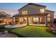 Spacious backyard with covered patio, putting green, and seating area at 6960 E Hacienda La Noria Ln, Gold Canyon, AZ 85118