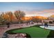 Landscaped backyard featuring a putting green and seating area at 6960 E Hacienda La Noria Ln, Gold Canyon, AZ 85118