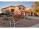 Two-story house with a three-car garage and desert landscaping at 6960 E Hacienda La Noria Ln, Gold Canyon, AZ 85118