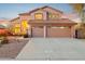 Two story house with a two car garage and lit windows at 6960 E Hacienda La Noria Ln, Gold Canyon, AZ 85118