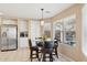 Kitchen nook with a glass table and chairs, overlooking the backyard at 6960 E Hacienda La Noria Ln, Gold Canyon, AZ 85118
