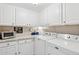 Laundry room with white cabinets and stacked washer/dryer at 6960 E Hacienda La Noria Ln, Gold Canyon, AZ 85118