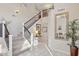 Elegant staircase with iron railings and tile flooring at 6960 E Hacienda La Noria Ln, Gold Canyon, AZ 85118