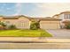 Charming single-story home featuring a tile roof, well-maintained lawn, and an attached two-car garage at 755 E Orchid Ln, Gilbert, AZ 85296
