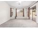 Bright bedroom with carpeting, large windows, and sliding door access to backyard at 9354 E Hillview Cir, Mesa, AZ 85207