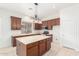 Spacious kitchen with an island, stainless steel appliances, and wood cabinets at 9354 E Hillview Cir, Mesa, AZ 85207