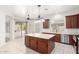 Bright kitchen featuring an island, stainless steel appliances, and wood cabinets at 9354 E Hillview Cir, Mesa, AZ 85207