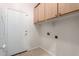 Laundry room with upper cabinets, washer/dryer hookups, and exterior access at 9354 E Hillview Cir, Mesa, AZ 85207