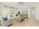 Inviting living room boasting neutral tones, tile floors, a cozy sofa, and bright natural light at 9354 E Hillview Cir, Mesa, AZ 85207