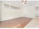 Living room with tile and wood-look flooring, and ceiling fan at 9354 E Hillview Cir, Mesa, AZ 85207