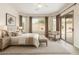 Bright main bedroom featuring ample natural light, a sitting area, and a sliding door for outdoor access at 9354 E Hillview Cir, Mesa, AZ 85207