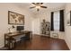 Functional office space including a work desk, shelving, and a large world map wall decoration at 9354 E Hillview Cir, Mesa, AZ 85207