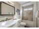 This bathroom has a single sink vanity, tub and shower with decorative tile, and a framed mirror at 11085 E Becker E Ln, Scottsdale, AZ 85259
