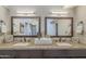This bathroom features double sinks with granite counters, a tile backsplash and modern fixtures at 11085 E Becker E Ln, Scottsdale, AZ 85259