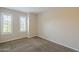 A bright bedroom is carpeted and has large windows with shutters at 11085 E Becker E Ln, Scottsdale, AZ 85259