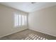 A bright bedroom is carpeted and has large windows with shutters at 11085 E Becker E Ln, Scottsdale, AZ 85259