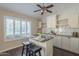 Charming breakfast bar area with granite counters, white cabinets and a pendant light, perfect for casual dining at 11085 E Becker E Ln, Scottsdale, AZ 85259