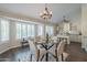 Bright dining space with a glass table set for four, surrounded by large windows and opening to the kitchen area at 11085 E Becker E Ln, Scottsdale, AZ 85259