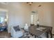 Bright dining area with tall ceilings, stylish lighting, and a view into other living spaces at 11085 E Becker E Ln, Scottsdale, AZ 85259