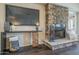 Close-up view of the living room's stone fireplace and built-in entertainment center at 11085 E Becker E Ln, Scottsdale, AZ 85259