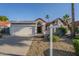 Charming single-story home featuring a well-manicured front yard and a two-car garage at 11085 E Becker E Ln, Scottsdale, AZ 85259