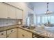 Kitchen sink, stainless steel appliances, and a breakfast bar with seating at 11085 E Becker E Ln, Scottsdale, AZ 85259