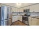 Well-equipped kitchen with stainless steel refrigerator and modern appliances at 11085 E Becker E Ln, Scottsdale, AZ 85259