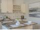 Kitchen featuring granite countertops, glass racks, stylish decor and white cabinets at 11085 E Becker E Ln, Scottsdale, AZ 85259