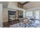 Stylish living room featuring a stone fireplace, dark wood floors, and an open layout at 11085 E Becker E Ln, Scottsdale, AZ 85259