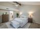 Serene main bedroom with neutral tones, a plush bed, wood-look ceiling fan, and an open doorway to the hallway at 11085 E Becker E Ln, Scottsdale, AZ 85259