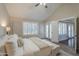 Airy main bedroom offering a plush bed, natural light through plantation shutters, and access to the backyard at 11085 E Becker E Ln, Scottsdale, AZ 85259