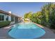 A blue inground pool surrounded by desert landscaping at 11085 E Becker E Ln, Scottsdale, AZ 85259