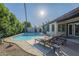 Inviting backyard oasis with a sparkling pool and lounge chairs for relaxation and sunbathing at 11085 E Becker E Ln, Scottsdale, AZ 85259