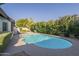 A bright blue pool surrounded by lush landscaping at 11085 E Becker E Ln, Scottsdale, AZ 85259