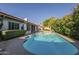Lush backyard with blue pool and mature foliage at 11085 E Becker E Ln, Scottsdale, AZ 85259