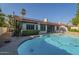 View of a backyard pool and home exterior with solar panels at 11085 E Becker E Ln, Scottsdale, AZ 85259