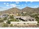 Enjoy an aerial view of this desert estate with a tile roof and mountain views at 13141 E Cibola Rd, Scottsdale, AZ 85259